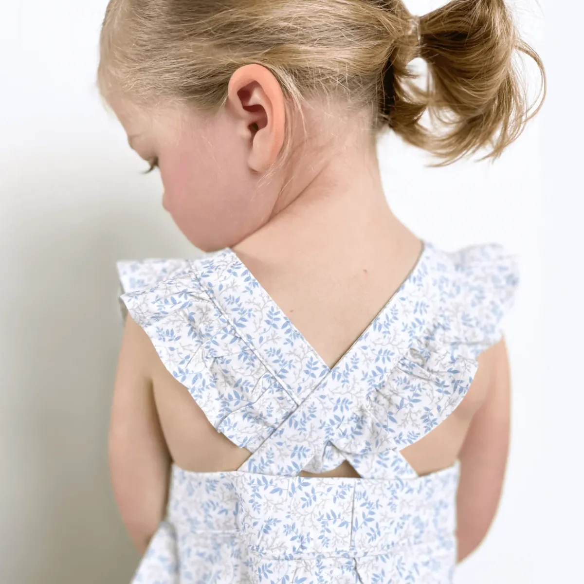 baby_girls_pinafore_rompe_2.webp minnow Rompers<Baby Girls Pinafore Romper Briland Blue Botanic